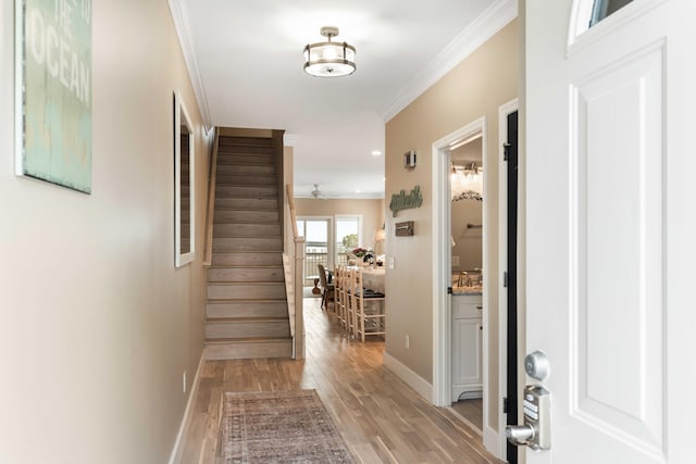 116 W 2nd St, Folly Beach, SC 29439 - foyer with baseboards, stairs, crown molding, light wood finished floors, and ceiling fan