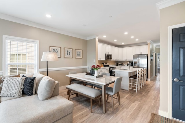 116 W 2nd St, Folly Beach, SC 29439 - dining area featuring crown molding, light wood-style flooring, recessed lighting, and baseboards