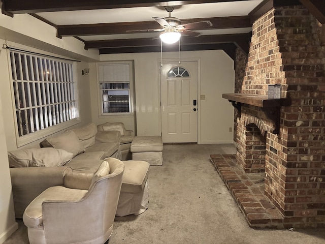 carpeted living room featuring ceiling fan, beam ceiling, and a brick fireplace