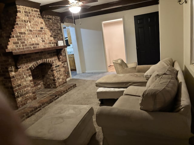 carpeted living room with beam ceiling, a fireplace, and ceiling fan