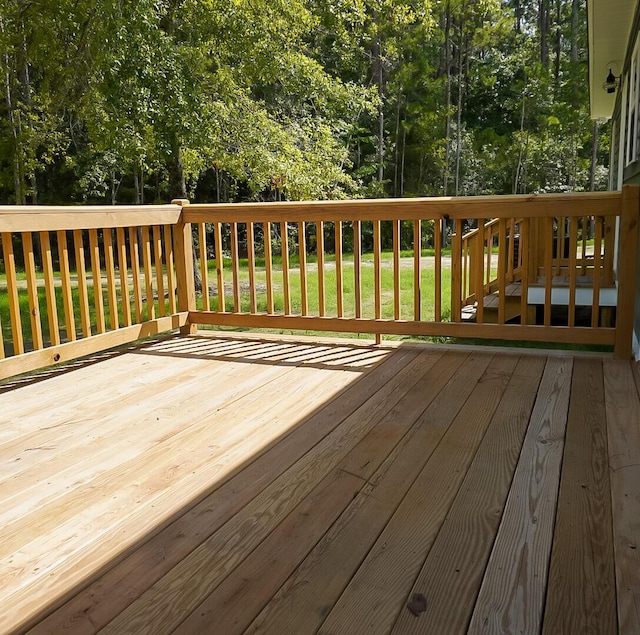 wooden deck with a lawn