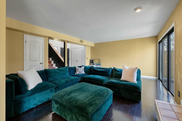 living area with stairs, visible vents, wood finished floors, and baseboards