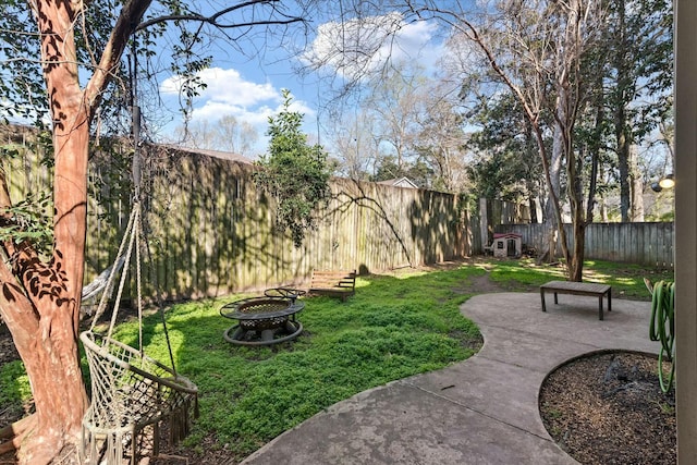 view of yard with a patio, a fire pit, and a fenced backyard