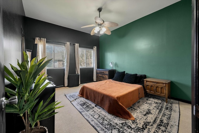 carpeted bedroom with baseboards and a ceiling fan