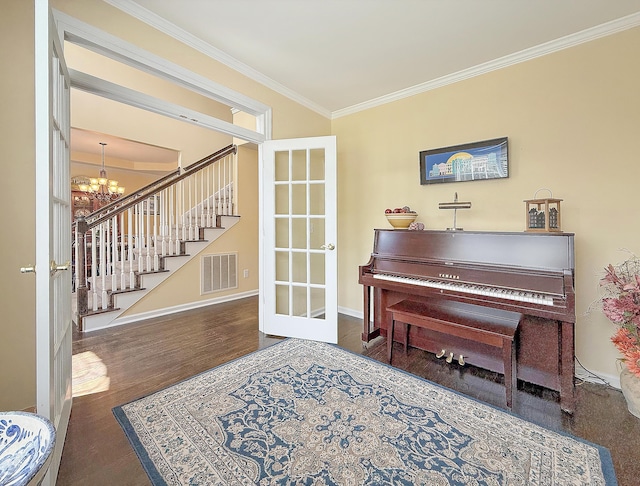 sitting room featuring a chandelier, ornamental molding, stairway, wood finished floors, and baseboards