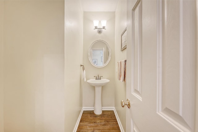 bathroom with wood finished floors and baseboards
