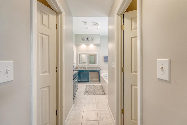 corridor with light tile patterned floors