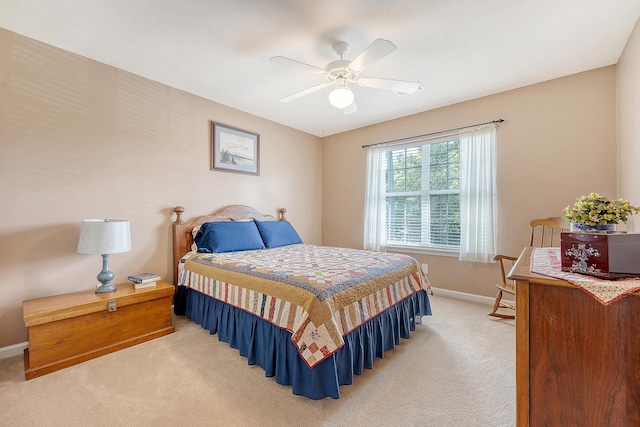 bedroom featuring light carpet, baseboards, and ceiling fan