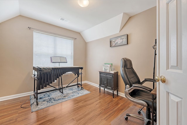 home office featuring lofted ceiling, wood finished floors, and baseboards