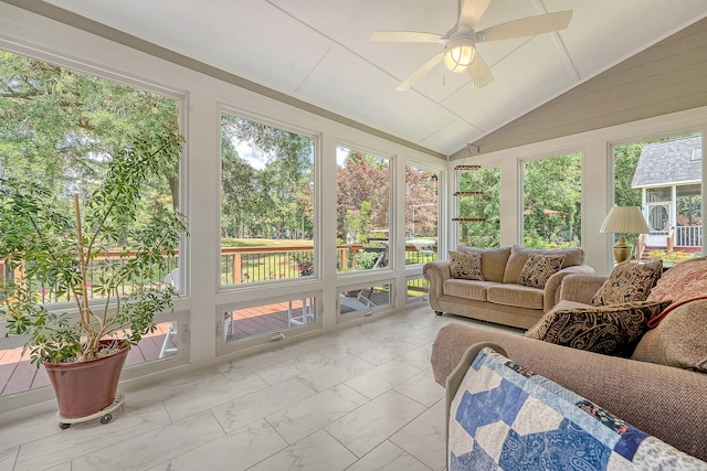 sunroom featuring marble look tiles, ceiling fan, an outdoor living space, and lofted ceiling