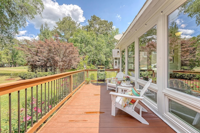 wooden deck featuring view of scattered trees
