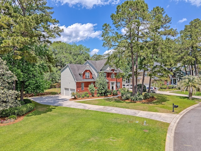 view of front facade with an attached garage, a front yard, and driveway