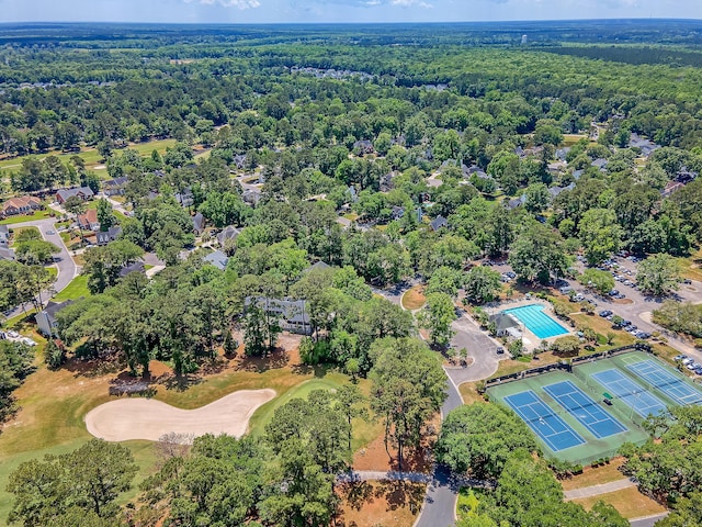 drone / aerial view of a heavily wooded area and a golf club
