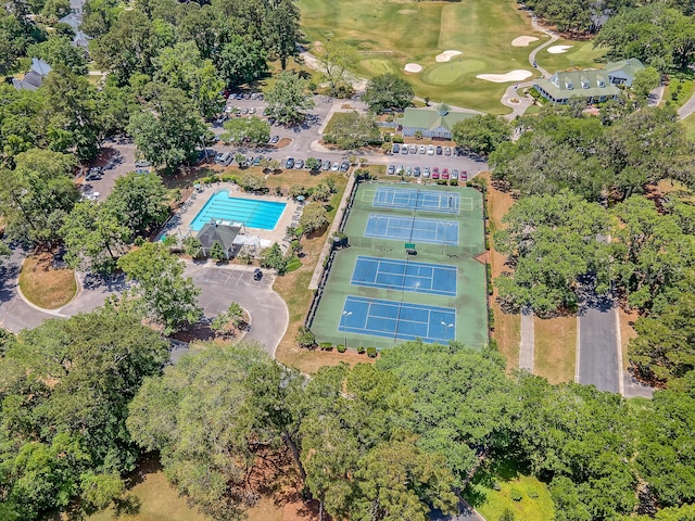 aerial overview of property's location with a local golf course and a pool area