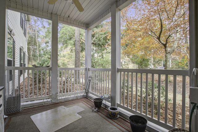 unfurnished sunroom with ceiling fan and a wealth of natural light