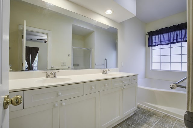 bathroom with vanity and shower with separate bathtub