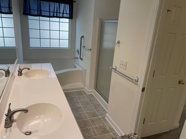 bathroom featuring tile patterned flooring, plus walk in shower, and vanity