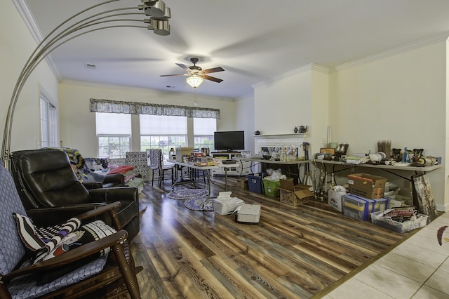 living room featuring crown molding, wood-type flooring, and ceiling fan