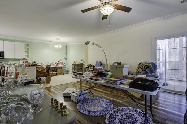 home office featuring dark wood-type flooring, ornamental molding, and ceiling fan