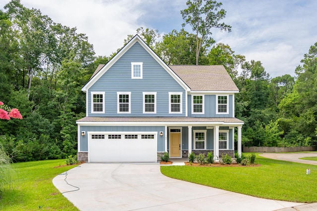 view of front of house with a garage, a front yard, and covered porch