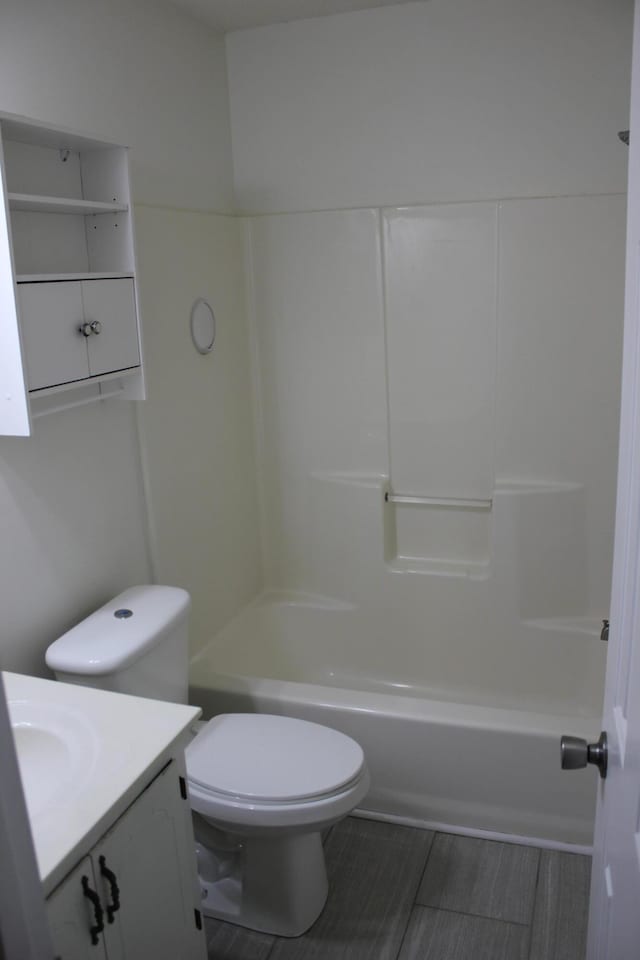 full bathroom with vanity, washtub / shower combination, and toilet