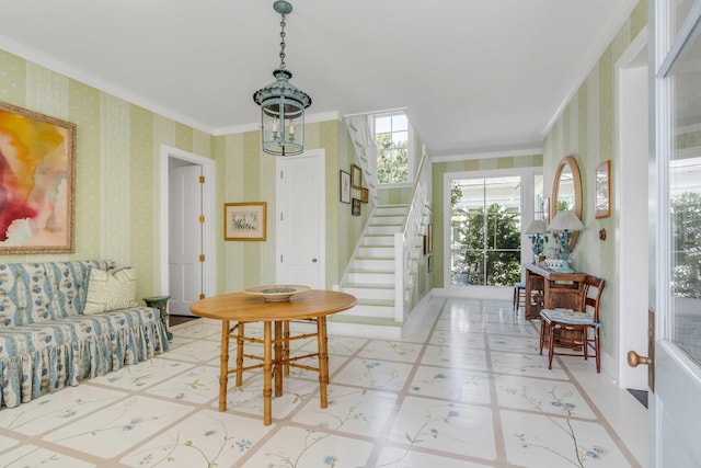 foyer featuring ornamental molding and a notable chandelier