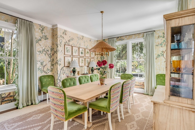 dining room with light carpet and crown molding