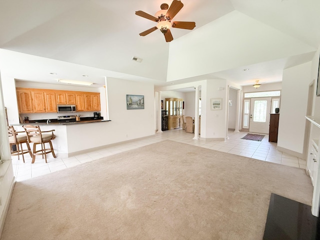 1804 Bass Rd, Moncks Corner, SC 29461 - unfurnished living room with light tile patterned floors, light carpet, a ceiling fan, and high vaulted ceiling
