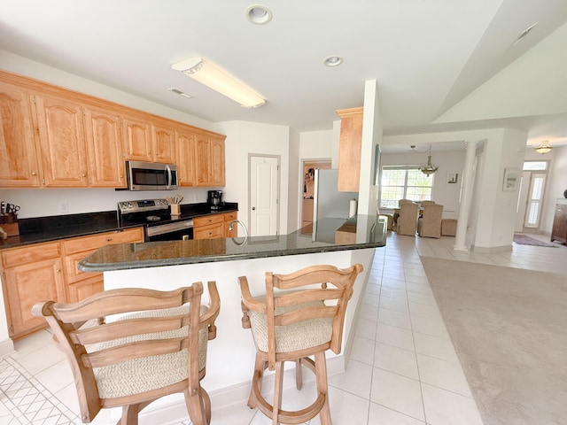 1804 Bass Rd, Moncks Corner, SC 29461 - kitchen featuring appliances with stainless steel finishes, light tile patterned flooring, dark countertops, recessed lighting, and ornate columns