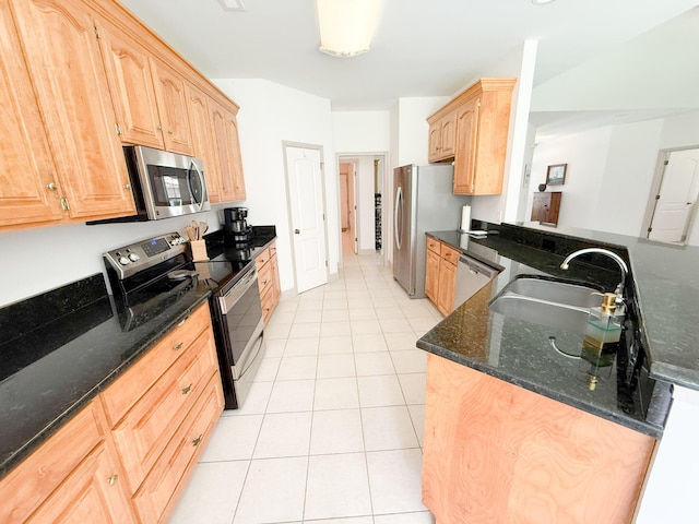 1804 Bass Rd, Moncks Corner, SC 29461 - kitchen with stainless steel appliances, light brown cabinetry, light tile patterned floors, dark stone counters, and a peninsula