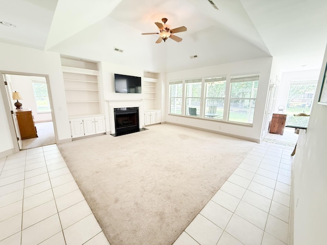 1804 Bass Rd, Moncks Corner, SC 29461 - unfurnished living room featuring light colored carpet, light tile patterned flooring, built in shelves, a fireplace with flush hearth, and vaulted ceiling
