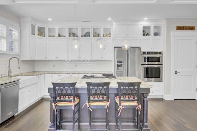 828 Bridge Point Cir, Mount Pleasant, SC 29464 - kitchen with stainless steel appliances, dark wood-style floors, white cabinetry, tasteful backsplash, and a sink