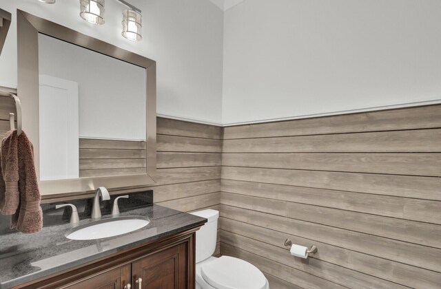 828 Bridge Point Cir, Mount Pleasant, SC 29464 - bathroom with toilet, vanity, and wooden walls