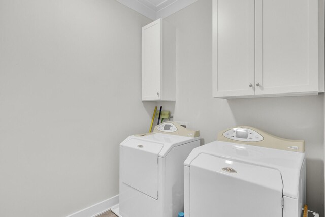 828 Bridge Point Cir, Mount Pleasant, SC 29464 - laundry area featuring cabinet space, washing machine and clothes dryer, crown molding, and baseboards