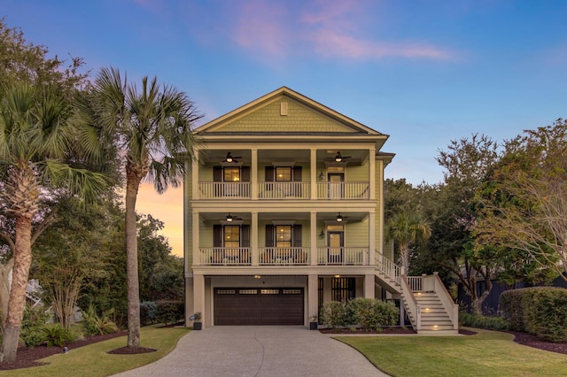 828 Bridge Point Cir, Mount Pleasant, SC 29464 - coastal home featuring a ceiling fan, stairs, a balcony, a yard, and concrete driveway