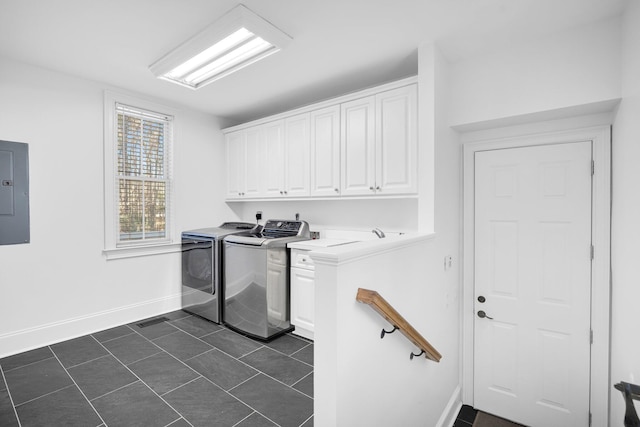 clothes washing area with washing machine and dryer, cabinets, electric panel, and dark tile patterned flooring