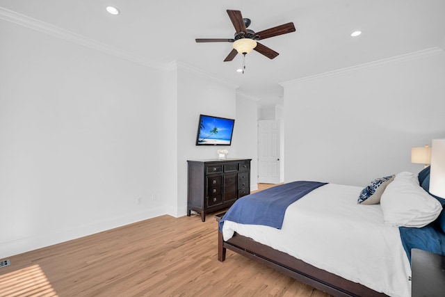 bedroom with ceiling fan, ornamental molding, and light hardwood / wood-style floors