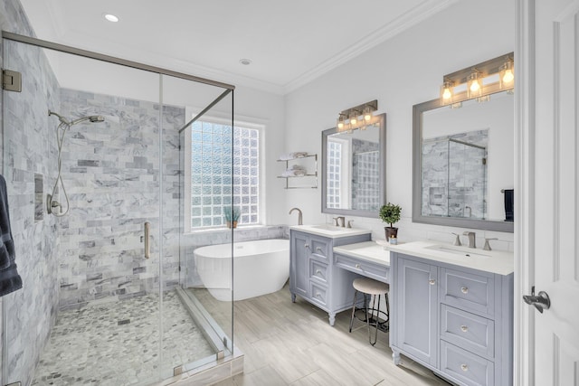 bathroom with vanity, crown molding, and separate shower and tub