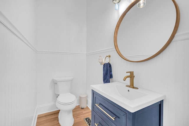 bathroom featuring toilet, wood-type flooring, and vanity