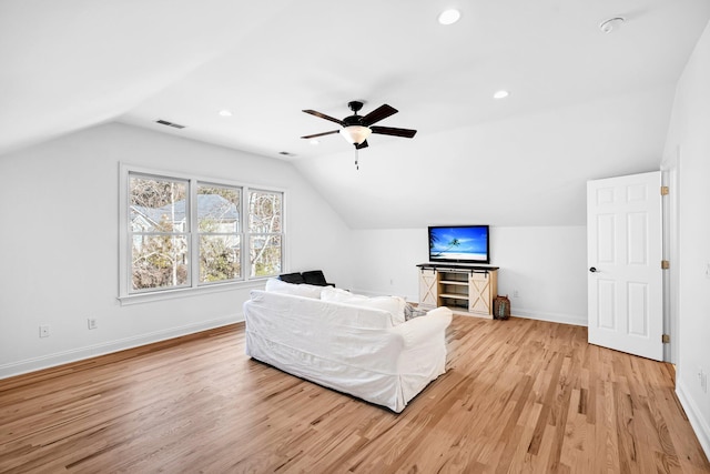 living room featuring ceiling fan, vaulted ceiling, and light hardwood / wood-style flooring