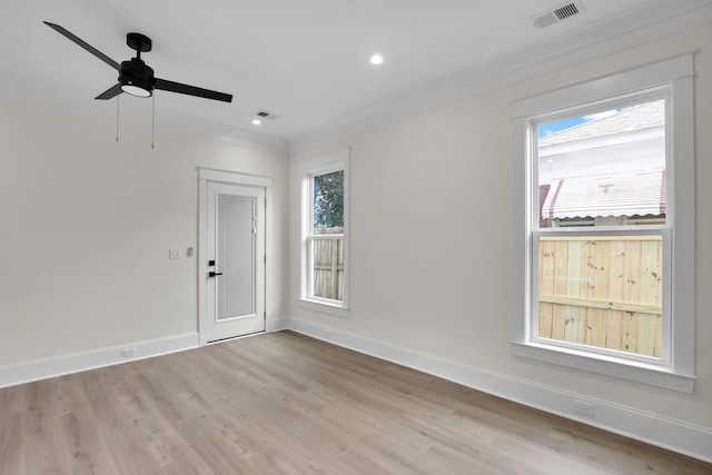 empty room with healthy amount of natural light, wood finished floors, baseboards, ceiling fan, and recessed lighting