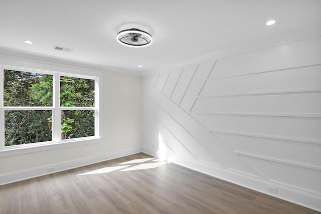 spare room featuring baseboards, wood finished floors, and recessed lighting