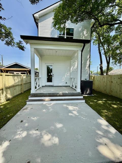 back of house featuring a porch