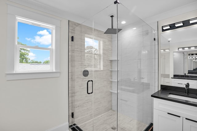 full bathroom featuring healthy amount of natural light, vanity, a stall shower, and recessed lighting