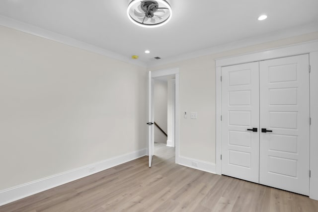 unfurnished bedroom with light wood-style flooring, baseboards, recessed lighting, a closet, and ornamental molding