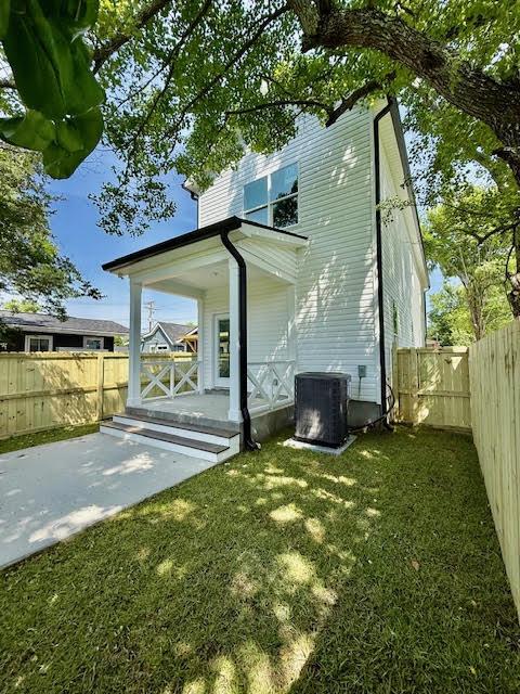 rear view of property with central AC, a porch, and a patio area