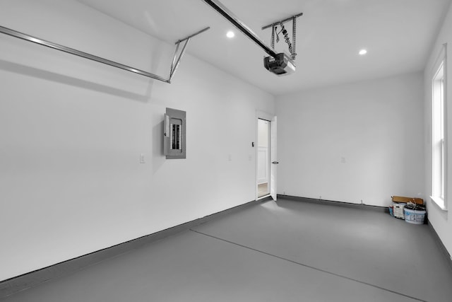 garage featuring electric panel, recessed lighting, and a garage door opener