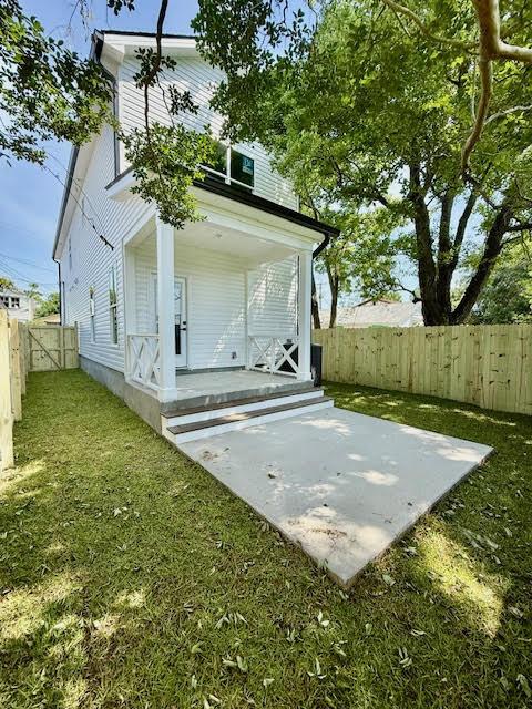 back of property with covered porch and a patio area