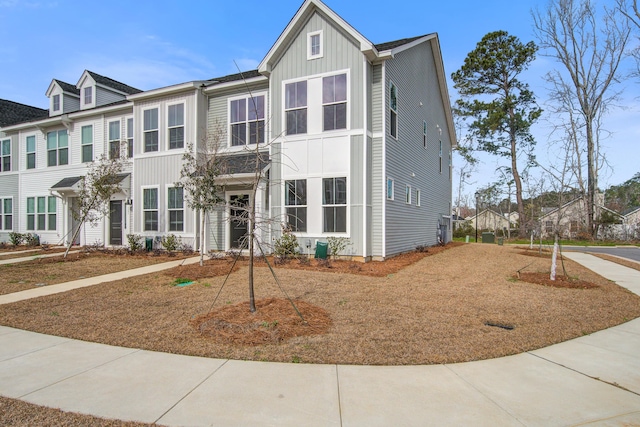 multi unit property with board and batten siding and a residential view