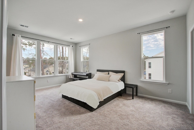 carpeted bedroom with baseboards, visible vents, and recessed lighting